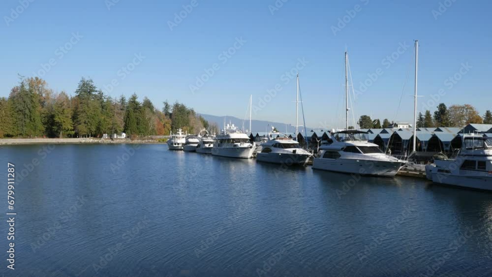 Beautiful view of Stanley Park during a fall season near Deadman's Island and the Royal Vancouver Yacht Club in Vancouver, British Columbia, Canada Beautiful view of Stanley Park during a fall season near Deadman's Island and the Royal Vancouver Yacht Club in Vancouver, British Columbia, Canada