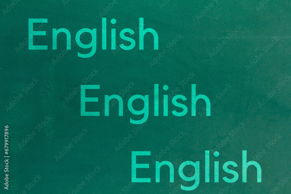 Background of old green wall. English letters on a green background Background of old green wall. English letters on a green background