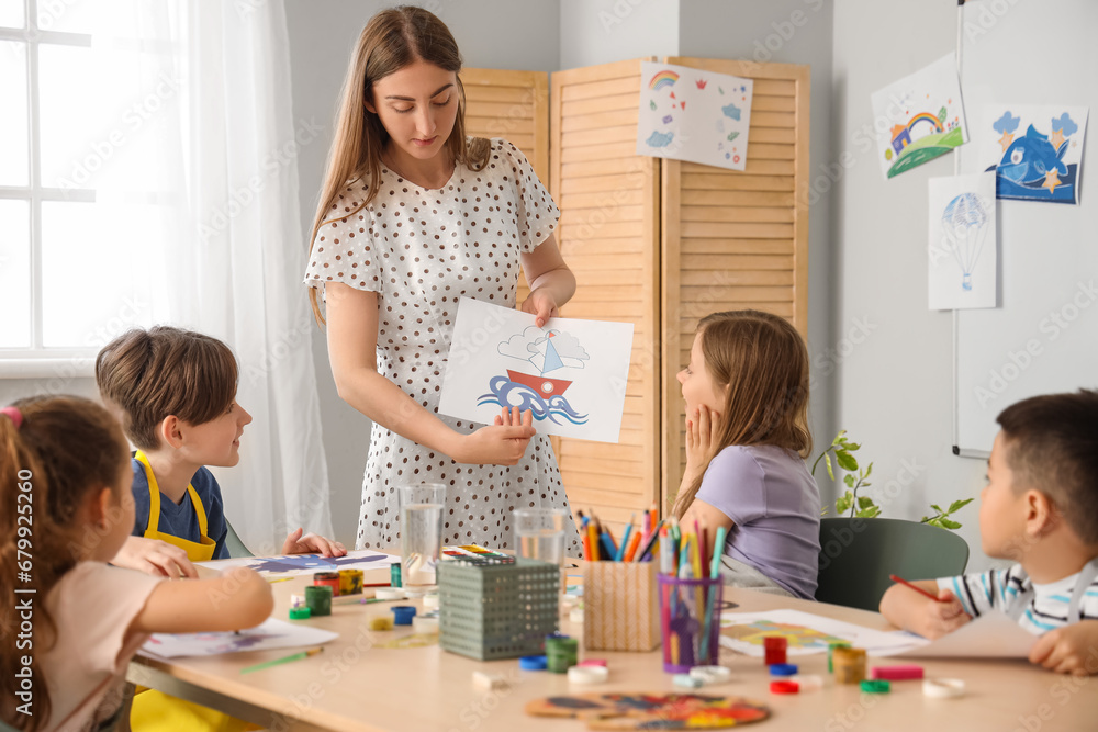 Fototapeta premium Little pupils with teacher in art class