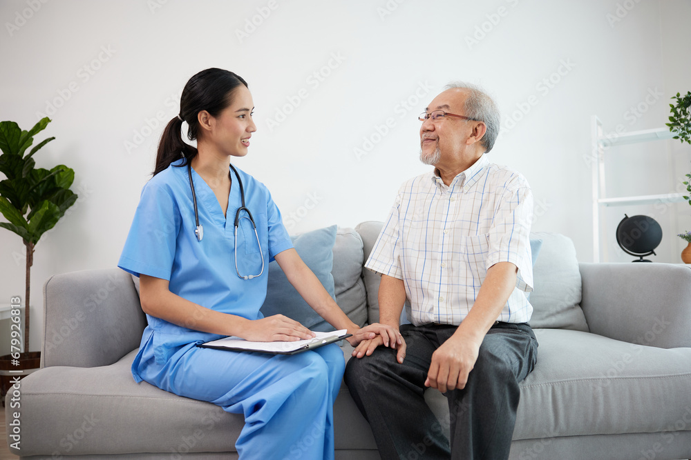 caregiver or nursing home holding hands and talking with senior man on sofa caregiver or nursing home holding hands and talking with senior man on sofa
