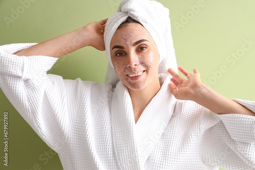 Young woman in bathrobe and...