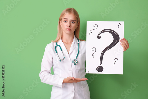 Female doctor holding paper...