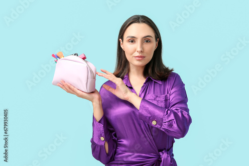 Young woman holding cosmeti...