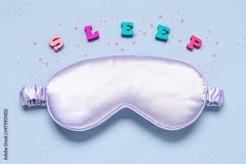 Composition with sleep mask, word SLEEP and sequins on color background photo