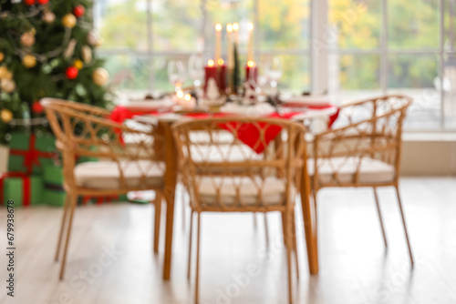 Blurred view of festive dining table with Christmas setting in room