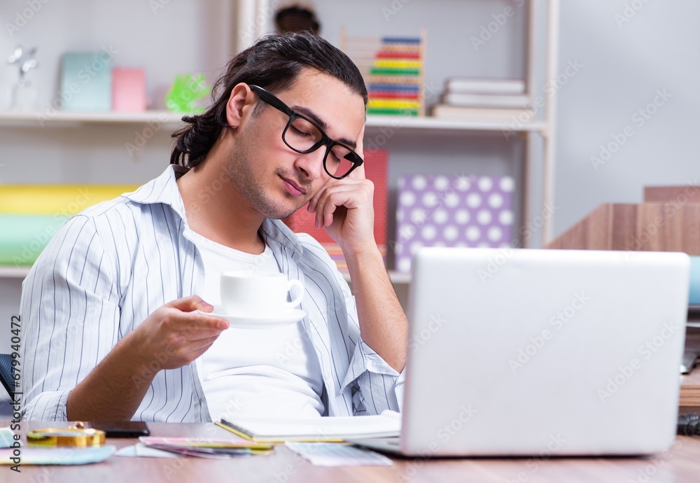 Young male designer working in the office Young male designer working in the office