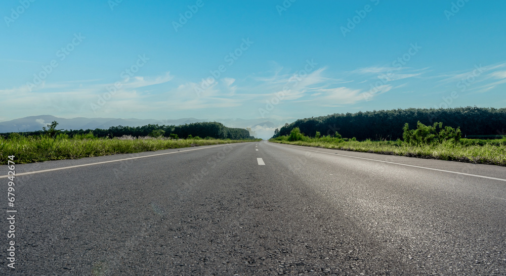 Empty asphalt road and mountain with blue sky scenery background.