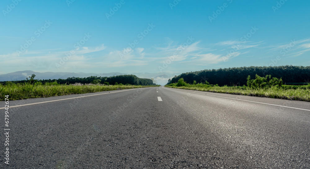 Empty asphalt road and mountain with blue sky scenery background. Empty asphalt road and mountain with blue sky scenery background.