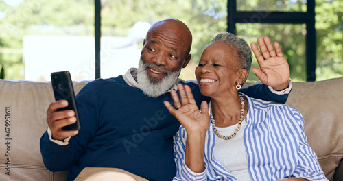 Happy senior couple, video call and smartphone in home for voip communication, social network or chat. African man, woman and wave hello for virtual conversation, mobile contact or talk in retirement photo