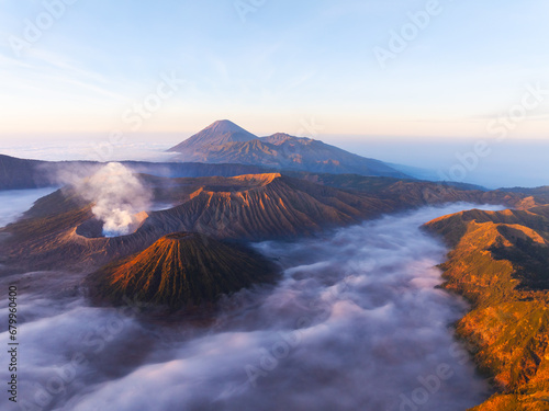 Aerial view Beautiful landscape scenery of Mount Bromo National Park from the top of the king kong hill,Amazing view landscape in indonesia,Beautiful sunrise and fog colorful sky background