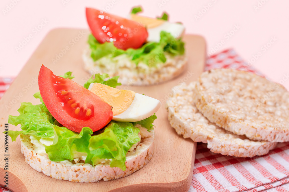 Rice Cake Sandwiches with Tomato, Lettuce and Egg on Wooden Cutting Board. Easy Breakfast. Diet Food. Quick and Healthy Sandwiches. Crispbread with Tasty Filling. Healthy Dietary Snack Rice Cake Sandwiches with Tomato, Lettuce and Egg on Wooden Cutting Board. Easy Breakfast. Diet Food. Quick and Healthy Sandwiches. Crispbread with Tasty Filling. Healthy Dietary Snack