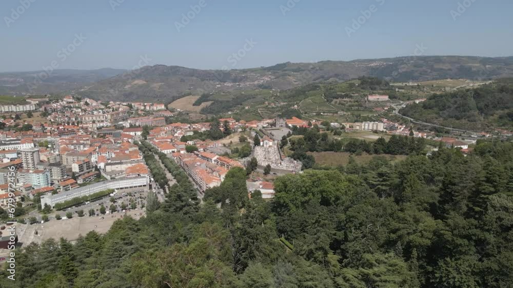 Aerial view of Lamego city, drone flying over the pine trees forest with Lamego city on the background. Camera moving forward and to the right. Aerial view of Lamego city, drone flying over the pine trees forest with Lamego city on the background. Camera moving forward and to the right.