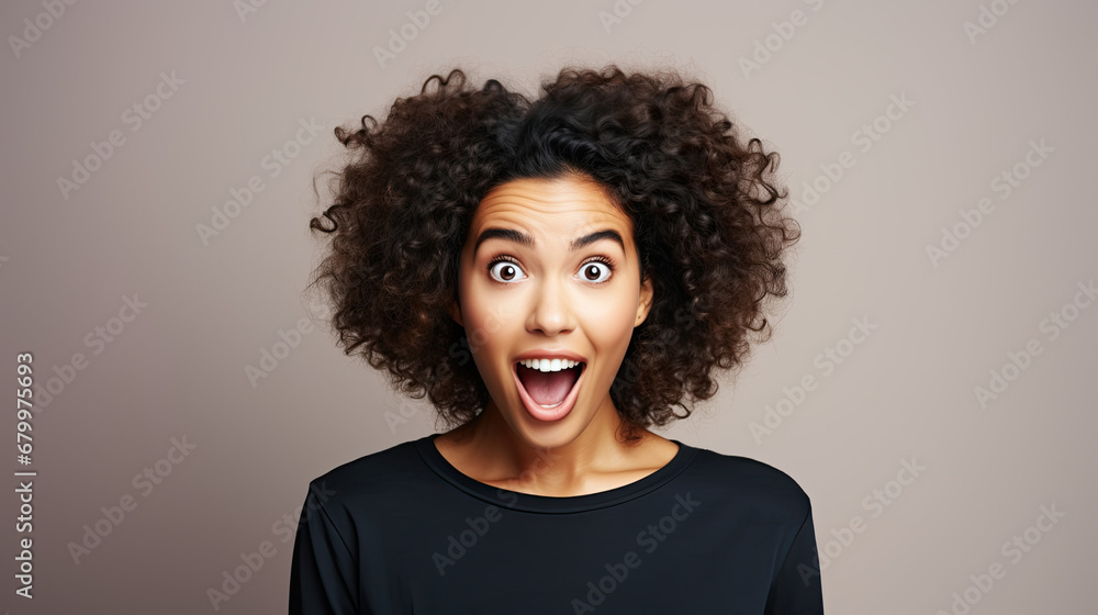 Funny surprised woman with a goofy face wearing black t-shirt isolated on brown background Funny surprised woman with a goofy face wearing black t-shirt isolated on brown background