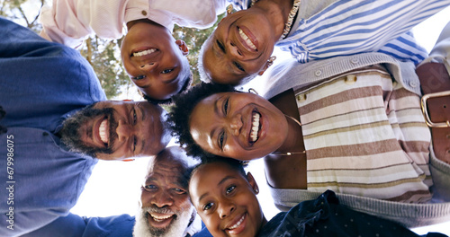 Happy family, huddle and circle portrait in nature, summer vacation and memory together with love. Black people, grandparents or parents with kids for smile, face or garden for relax bond with below © Charlize D/peopleimages.com