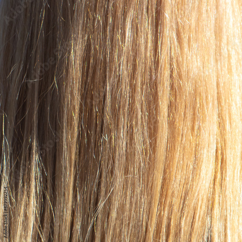 Straight female blonde hair background. Texture