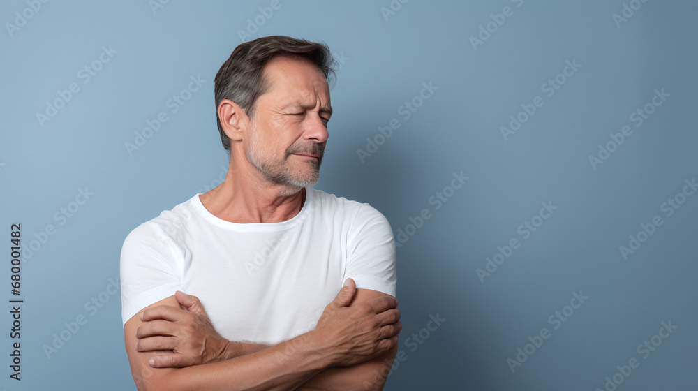 diseases and illnesses - man with face distorted in pain holds one hand at his neck,shoulder or upper arm diseases and illnesses - man with face distorted in pain holds one hand at his neck,shoulder or upper arm