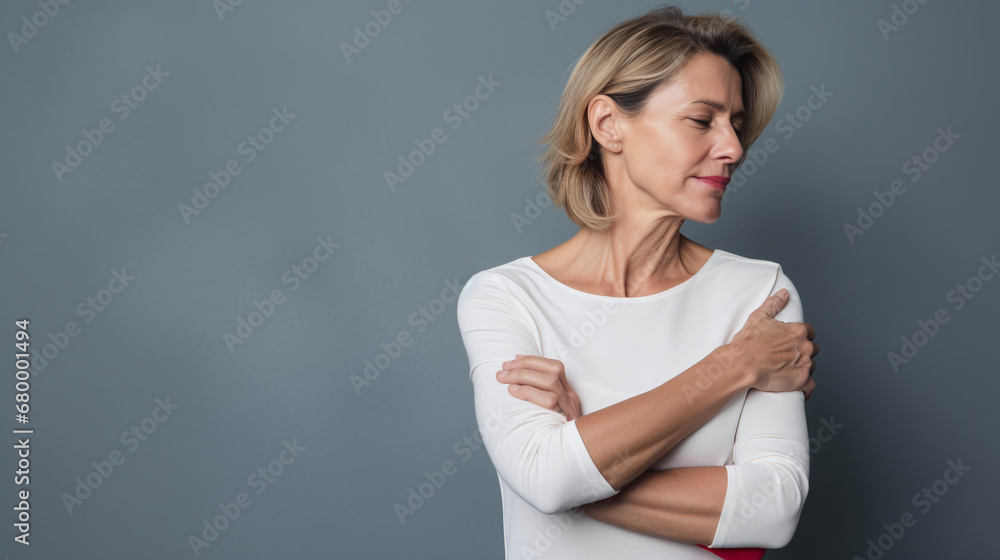 diseases and illnesses - woman with face distorted in pain holds one hand at his neck,shoulder or upper arm - obrazy, fototapety, plakaty 