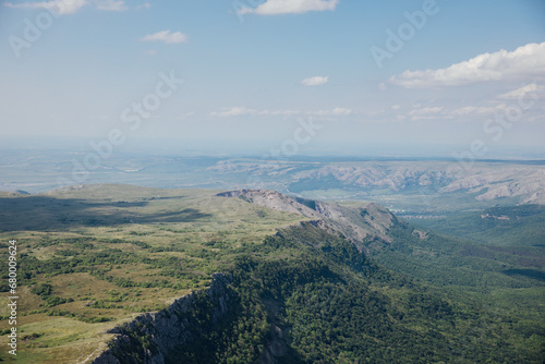 Beautiful landscape on top of mountain green forest and sky cliffs © dmitriisimakov