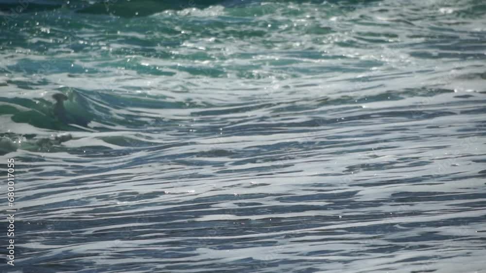 Sea water surface. Low angle view over clear azure sea water. Sun glare. Abstract nautical summer ocean nature. Holiday, vacation and travel concept. Nobody. Slow motion. Weather and climate change Sea water surface. Low angle view over clear azure sea water. Sun glare. Abstract nautical summer ocean nature. Holiday, vacation and travel concept. Nobody. Slow motion. Weather and climate change