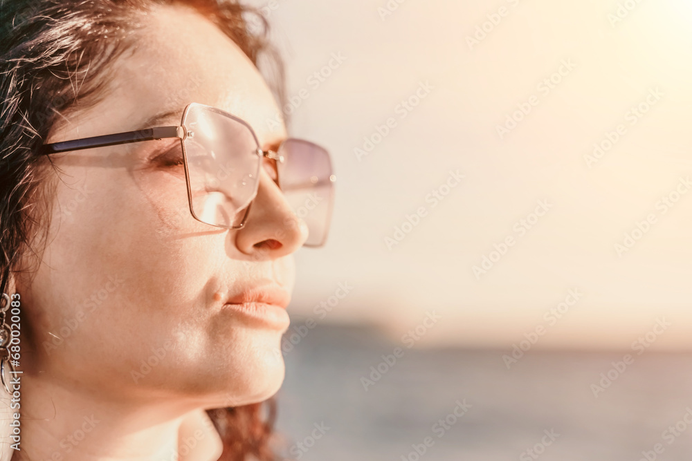 Portrait of a curly woman in glasses on the background of the se Portrait of a curly woman in glasses on the background of the se