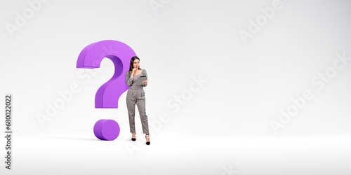 Pensive woman with tablet and big question mark