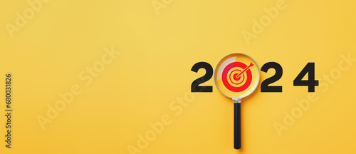 2024 Goal and planning concept, Magnifying glass focus on target aiming dart board, Business achievement objective goal and project progress growth value processing marketing financial, Reach target photo