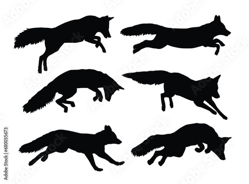 The set silhouettes of foxes on the run.