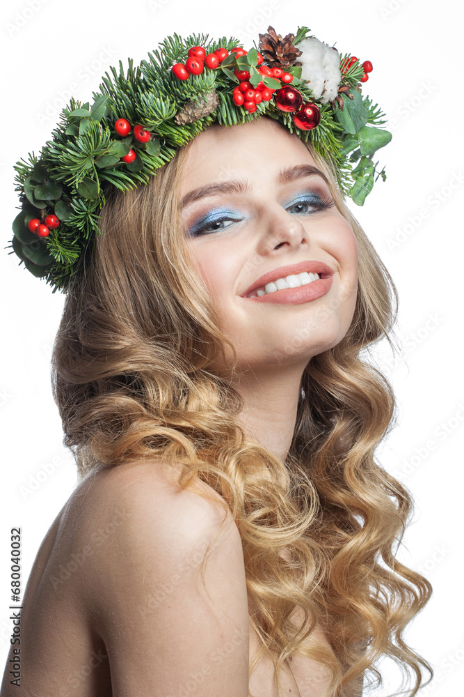 Smiling healthy young woman with party makeup, long blonde curly hairdo and Christmas decor isolated on white background. Christmas beauty