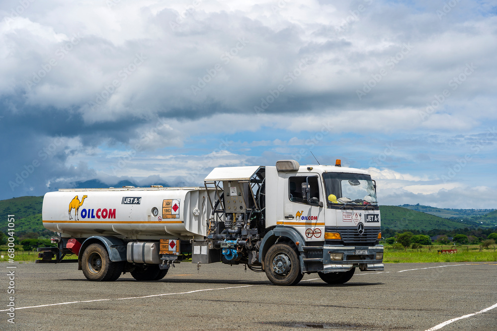 Fuel truck is waiting to fill up some airplanes with liquid fuel at