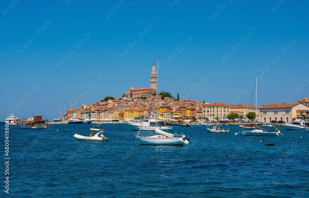 Boats on the historic waterfront of the medieval coastal town of Rovinj in Istria, Croatia. Saint Euphemia Church is central