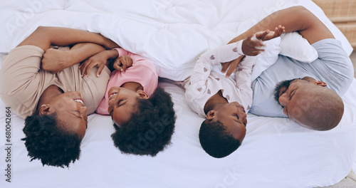 Bedroom, relax and black family parents, happy kids or people bonding, love and care young youth. Home wellness, happiness and African children, father and mother support, comfort and smile on bed #680042664
