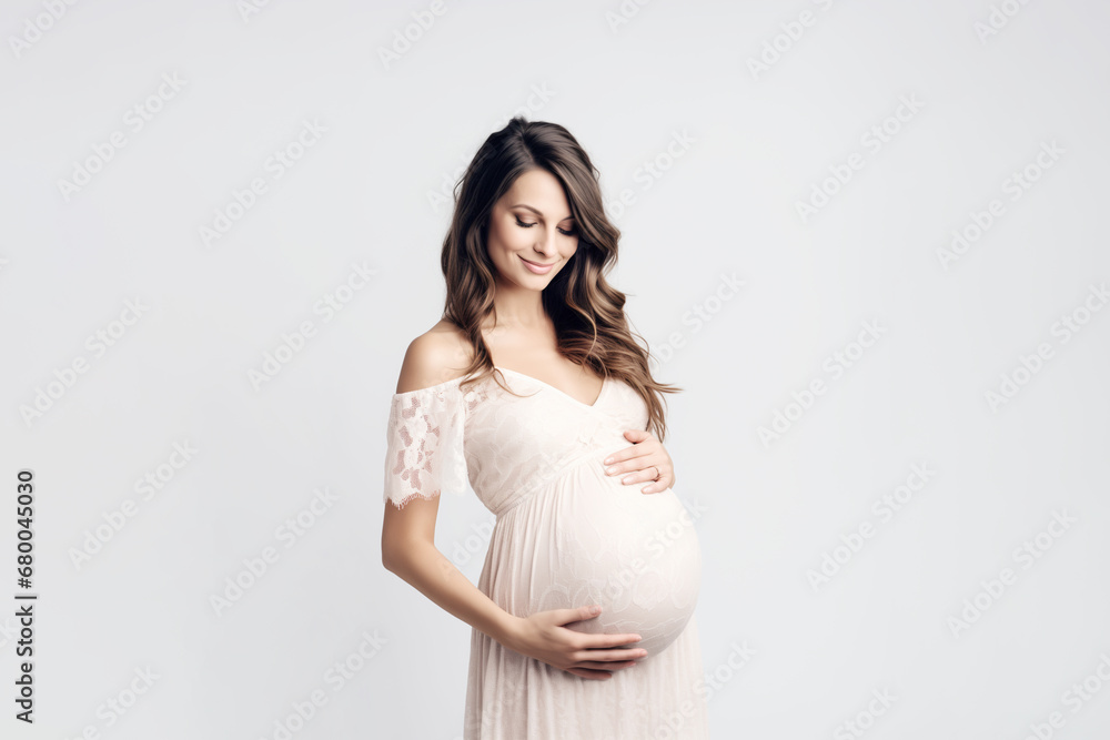 Pregnant young woman in dress holds hands on belly on a white background. Concept of pregnancy, maternity, preparation and expectation. Pregnant young woman in dress holds hands on belly on a white background. Concept of pregnancy, maternity, preparation and expectation.