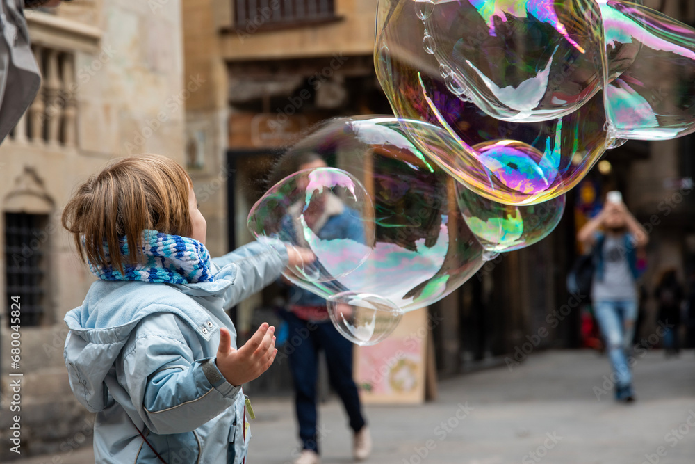 Child Playing with Giant Soap Bubbles in the Gothic Quarter Child Playing with Giant Soap Bubbles in the Gothic Quarter