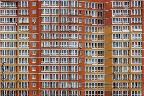 large russian cheap apartment building wall with enormous quantity of windows, full-frame background and texture
