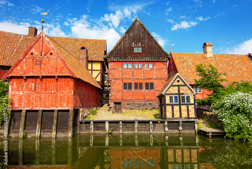 Half-Timbered Traditional Danish Houses near pond at Den Gamle By (The Old Town in English), an open-air town museum located in the Aarhus, Denmark