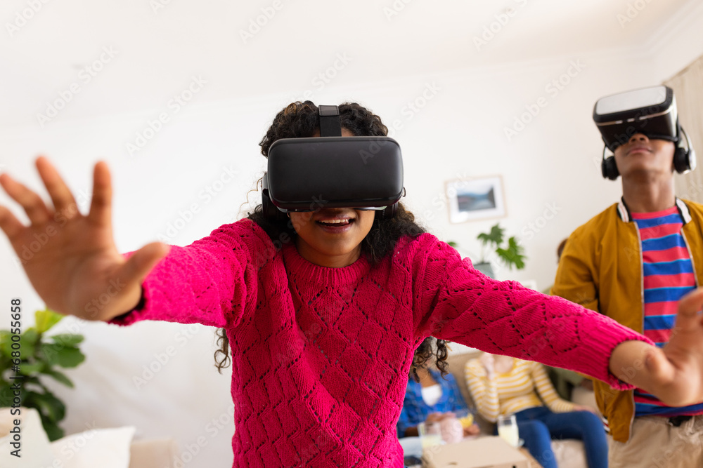 Portrait of happy diverse group of teenage friends using vr headsets and playing at home Portrait of happy diverse group of teenage friends using vr headsets and playing at home