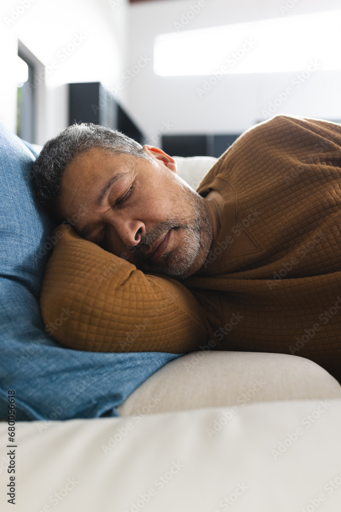 Senior biracial man lying on couch and sleeping at home Senior biracial man lying on couch and sleeping at home