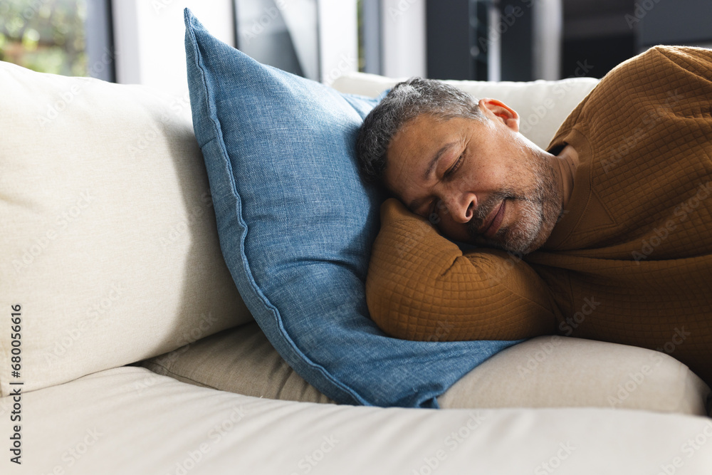 Senior biracial man lying on couch and sleeping at home Senior biracial man lying on couch and sleeping at home