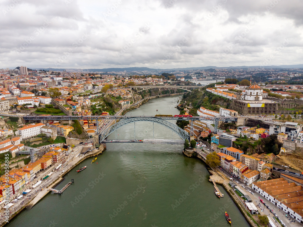 Beautiful spectacular aerial perspective of Porto City. View of River Douro and Dom Luis I Bridge. Famous travel destination in Portugal. Cloudy day.