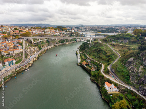 Beautiful spectacular aerial perspective of Porto City. View of River Douro and Dom Luis I Bridge. Famous travel destination in Portugal. Cloudy day.