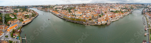 Panoramic aerial view of Porto city. View of Douro River. At right is Dom Luis I Bridge  at left Ponte da Arrabida. Panoramic perspective of old town center. Cloudy day. Famous travel destination. 