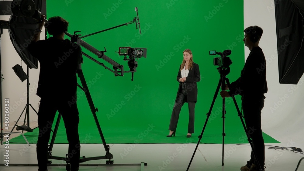 Φωτογραφία News anchor at work, woman journalist presenter telling weather news, view of a backstage studio TV news shooting, chroma key template