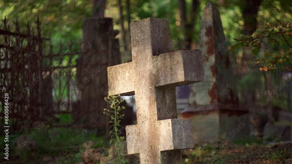 sunset, the old concrete cross stands in cemetery, surrounded by religious symbols and graves of soldiers and civilians from First World War. It is place of peace and tranquility. sunset, the old concrete cross stands in cemetery, surrounded by religious symbols and graves of soldiers and civilians from First World War. It is place of peace and tranquility.