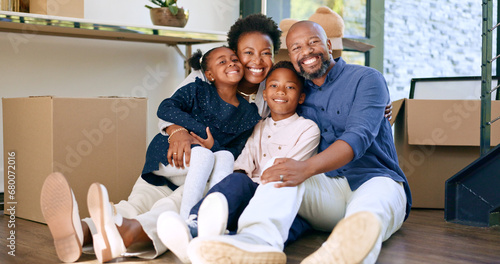 Moving, portrait and happy black family in home with boxes and hug in living room together. New house, property and smile for investment in real estate, growth and parents embrace children on floor photo