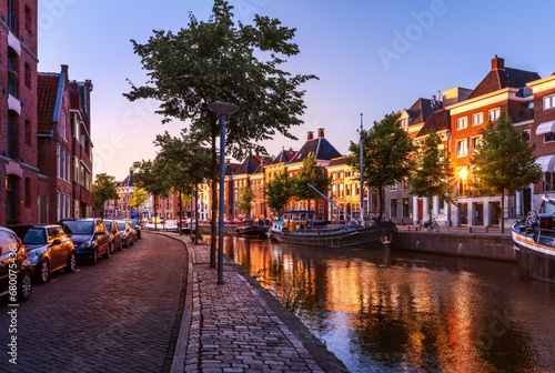 Dutch canal with boats at sunset. Groningen Street, Netherlands.