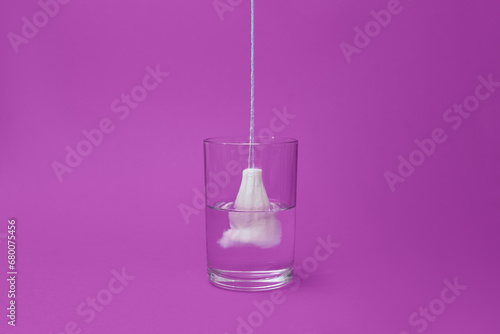 Female hygienic tampon full of water photo