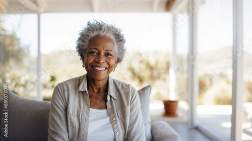 Senior african american woman happy sitting on her sofa in the living room at home, smiling retired pensioner, healthy mature black woman hd photo