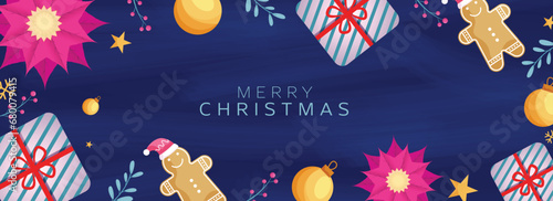 Merry Christmas Text with Top View of Gift Boxes, Baubles, Smiley Gingerbread, Gift Boxes and Poinsettia Flower on Blue Texture Background.