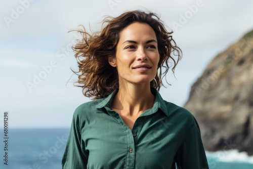 Portrait of a tender woman in her 30s sporting a breathable hiking shirt against a tranquil ocean backdrop. AI Generation