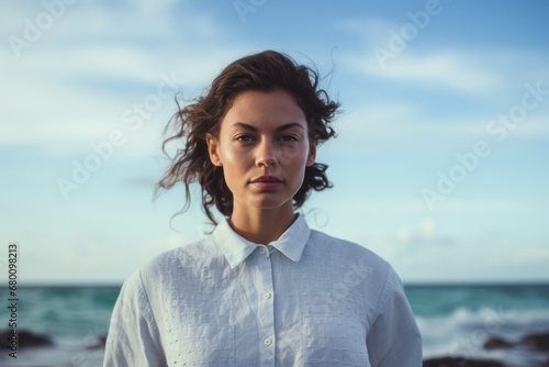 Portrait of a content woman in her 20s wearing a simple cotton shirt against a stunning ocean reef. AI Generation © CogniLens